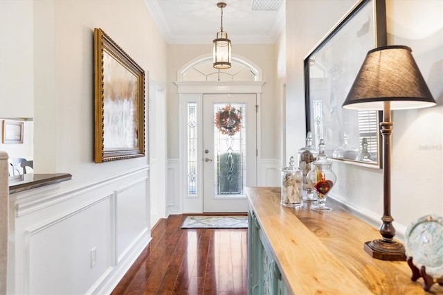 foyer featuring crown molding and dark hardwood / wood-style flooring