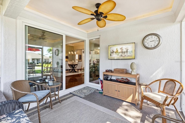 sunroom / solarium featuring ceiling fan