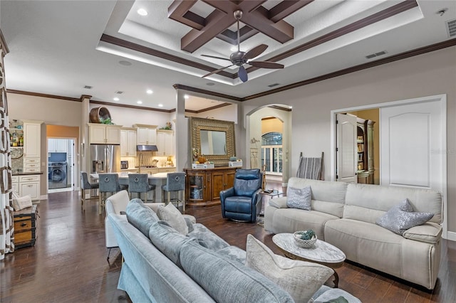 living room with crown molding, ceiling fan, dark hardwood / wood-style flooring, and washer / clothes dryer