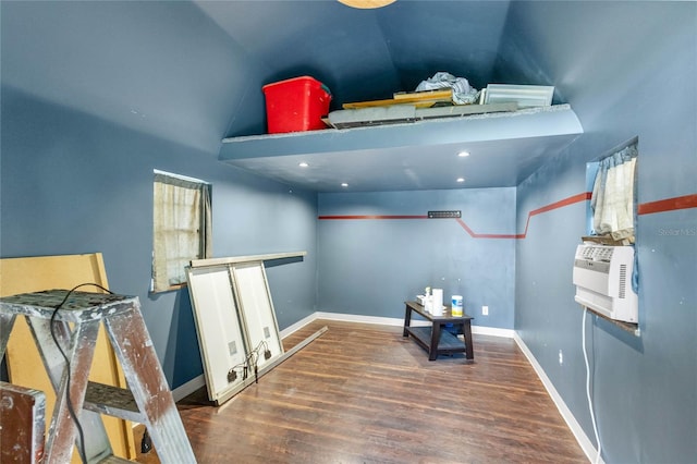 interior space with cooling unit, hardwood / wood-style floors, and vaulted ceiling