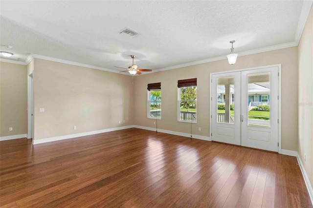 empty room featuring ceiling fan, dark hardwood / wood-style flooring, french doors, a textured ceiling, and ornamental molding