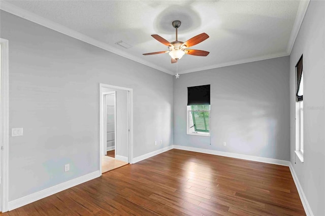 spare room with a textured ceiling, ceiling fan, ornamental molding, and hardwood / wood-style floors