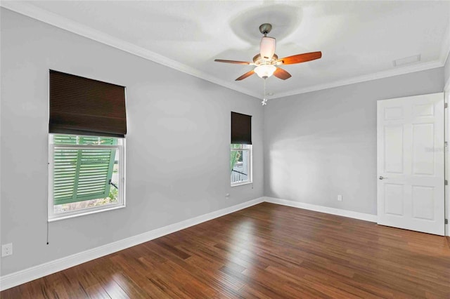 empty room with ceiling fan, dark hardwood / wood-style flooring, and ornamental molding