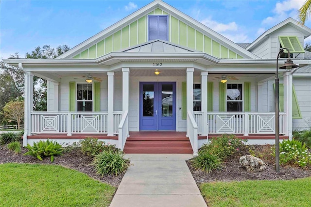 view of exterior entry featuring ceiling fan, a porch, and french doors