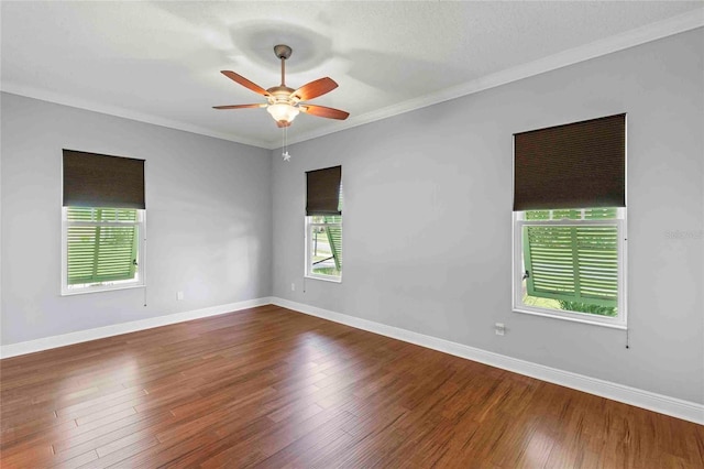 unfurnished room featuring ceiling fan, dark hardwood / wood-style flooring, and ornamental molding