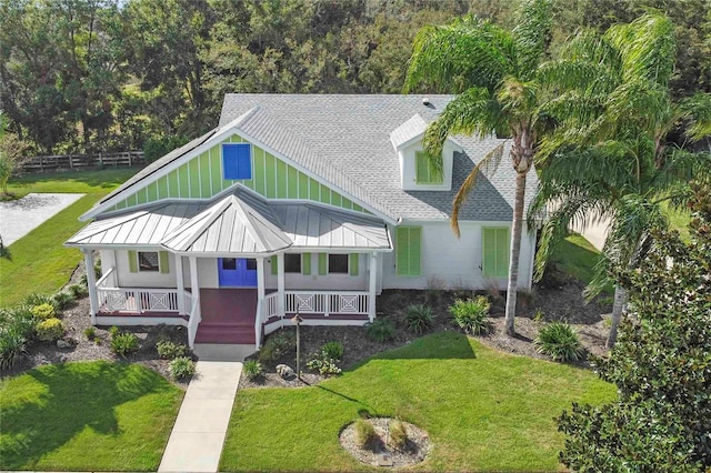 view of front of house with a front yard and a porch