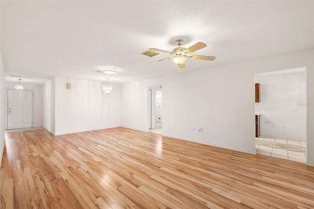 spare room with light hardwood / wood-style flooring and ceiling fan