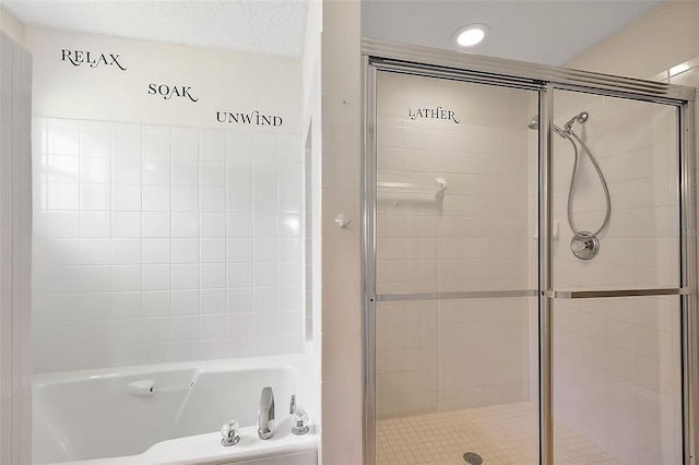 bathroom featuring shower with separate bathtub