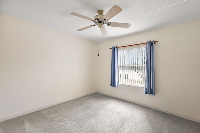 unfurnished room with a textured ceiling, carpet flooring, and ceiling fan