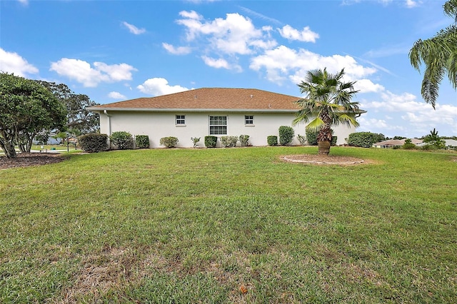 back of house featuring a yard