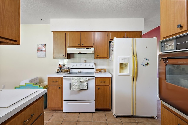 kitchen with backsplash, a textured ceiling, white appliances, and light tile patterned floors