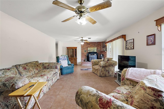 tiled living room featuring ceiling fan and a wood stove