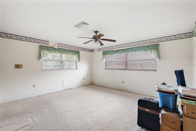 carpeted spare room with ceiling fan