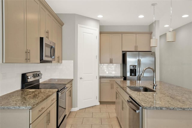 kitchen with backsplash, light tile patterned flooring, sink, pendant lighting, and stainless steel appliances