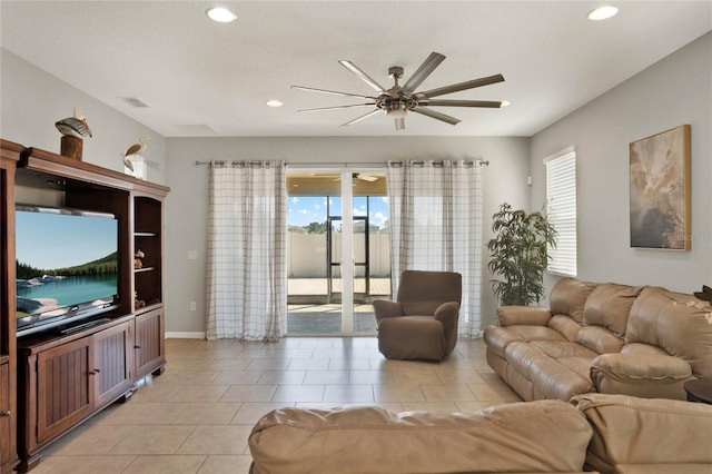 living room featuring light tile patterned flooring, a healthy amount of sunlight, and ceiling fan