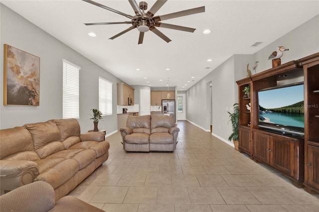 living room with light tile patterned flooring, sink, and ceiling fan