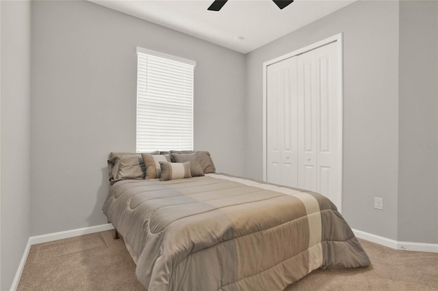 bedroom with light carpet, a closet, and ceiling fan