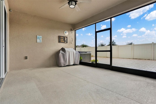 unfurnished sunroom featuring ceiling fan