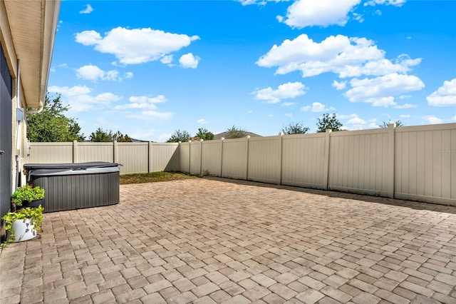 view of patio / terrace with a hot tub