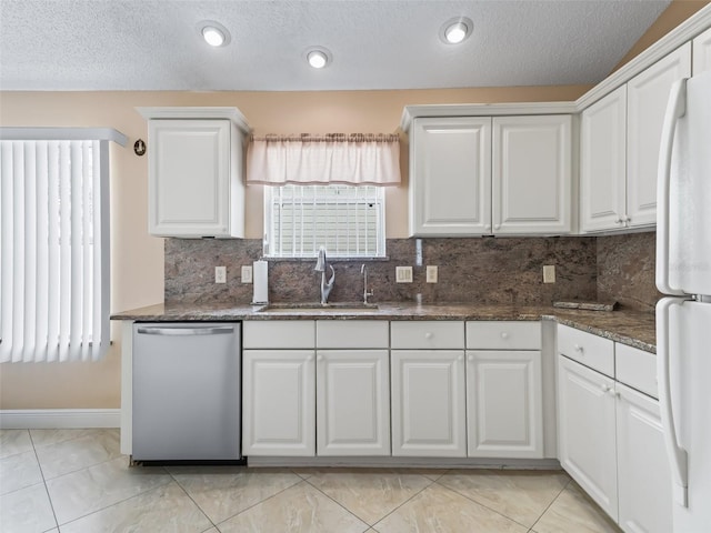 kitchen featuring dishwasher, sink, backsplash, white cabinetry, and white fridge