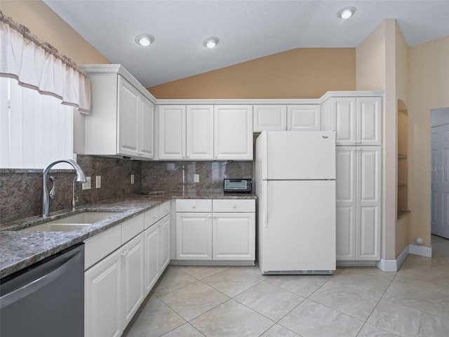 kitchen with dishwasher, vaulted ceiling, white cabinetry, and white refrigerator