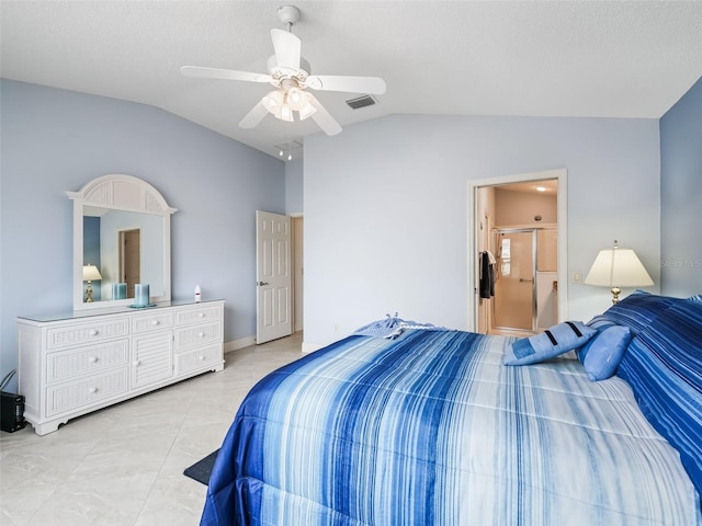 bedroom with connected bathroom, vaulted ceiling, light tile patterned floors, a textured ceiling, and ceiling fan