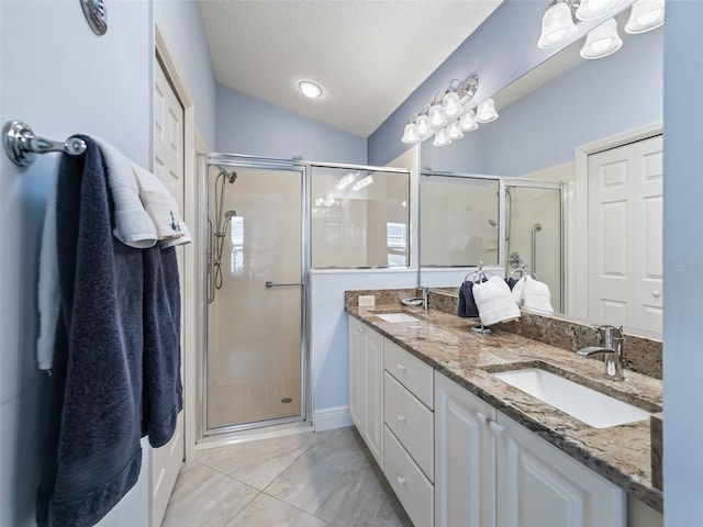 bathroom with vanity, a textured ceiling, lofted ceiling, and an enclosed shower