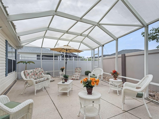 view of patio featuring an outdoor living space and glass enclosure