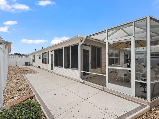 rear view of house with a patio area and central AC unit