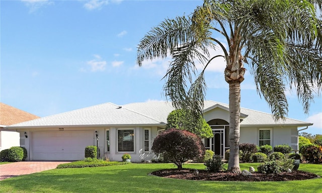 ranch-style house featuring a front lawn and a garage