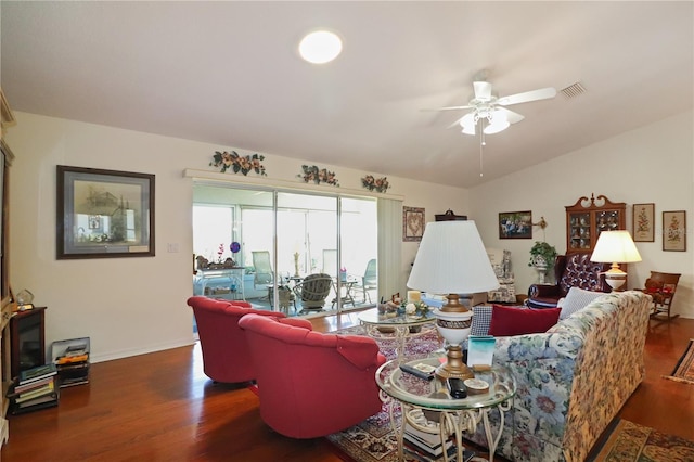 living room featuring dark hardwood / wood-style floors, vaulted ceiling, and ceiling fan