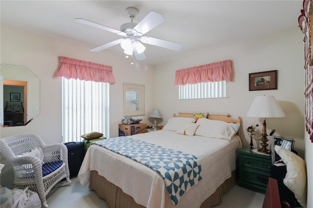 carpeted bedroom with multiple windows and ceiling fan