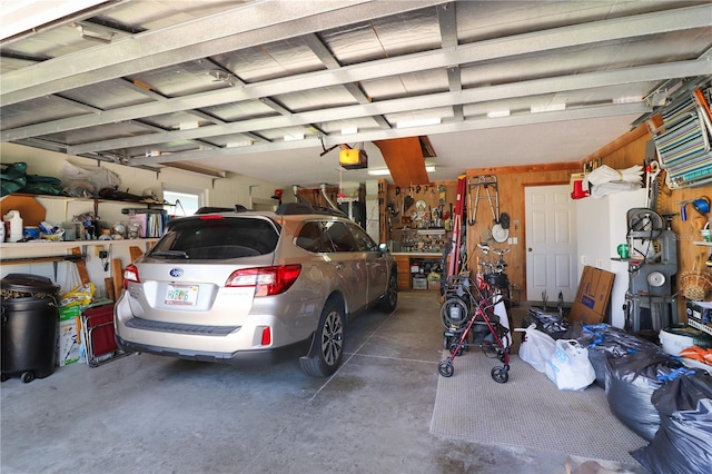 garage featuring a garage door opener and a workshop area