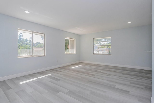 unfurnished room with a healthy amount of sunlight and light wood-type flooring