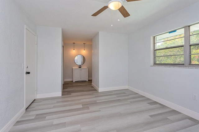 unfurnished room with light hardwood / wood-style floors and ceiling fan