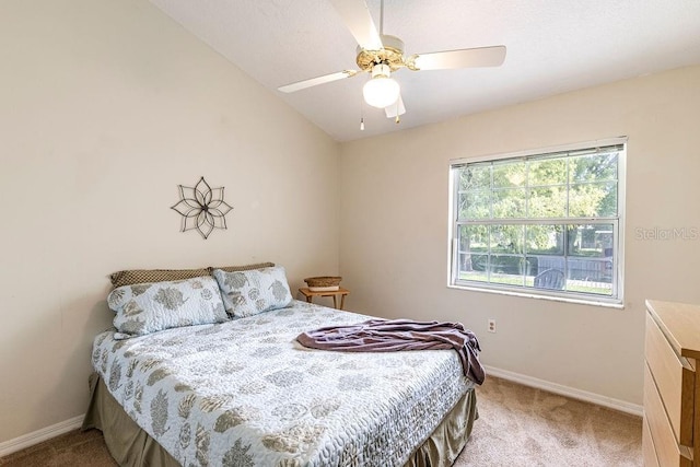 carpeted bedroom with lofted ceiling and ceiling fan