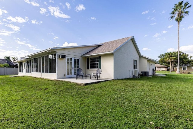 back of house with a patio, cooling unit, a sunroom, and a lawn