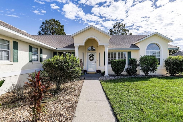 single story home featuring a front yard