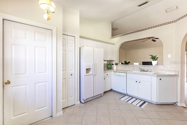 kitchen with white appliances, light tile patterned floors, ceiling fan, sink, and white cabinetry