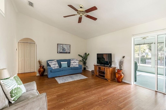 living room featuring ceiling fan, vaulted ceiling, and hardwood / wood-style floors