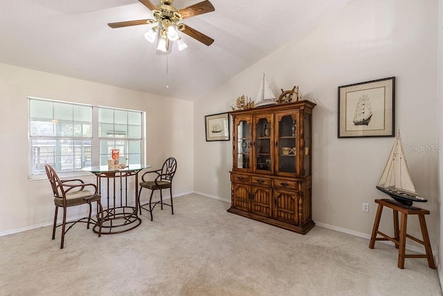 sitting room with lofted ceiling, ceiling fan, and light colored carpet