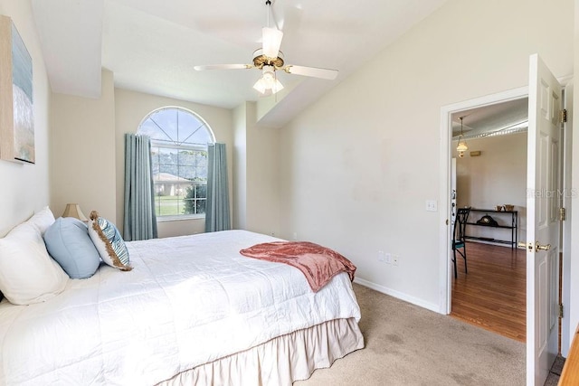 carpeted bedroom featuring vaulted ceiling and ceiling fan