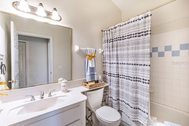 full bathroom with vanity, shower / bath combo with shower curtain, and toilet