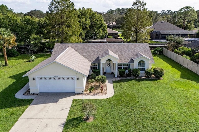 view of front of property featuring a front yard and a garage