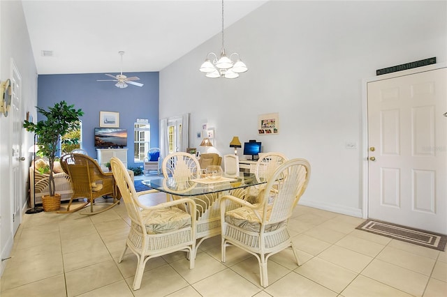 dining area featuring ceiling fan with notable chandelier, light tile patterned floors, and high vaulted ceiling