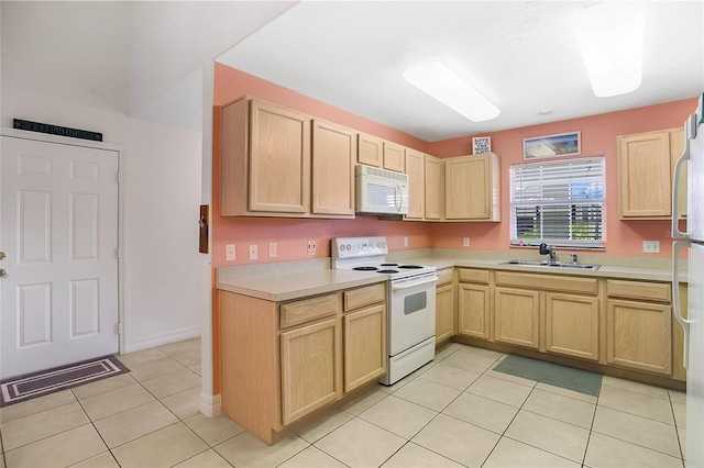 kitchen featuring light brown cabinets, white appliances, sink, and light tile patterned floors