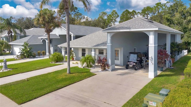 view of front of property featuring a front yard and a carport