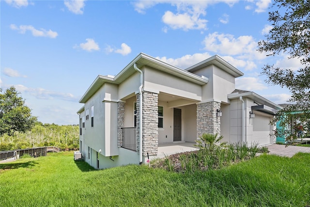 1180 Dora Parc Ln, Mount Dora, FL 32757 - view of front of property with stucco siding, stone siding, a garage, a front lawn, and driveway