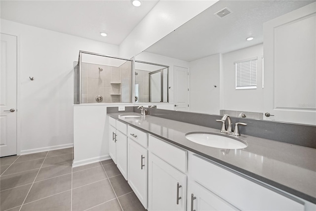 bathroom with vanity, tile patterned flooring, and an enclosed shower