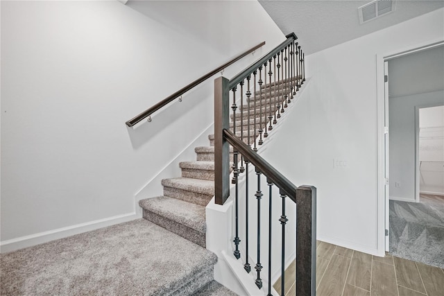 staircase featuring hardwood / wood-style floors